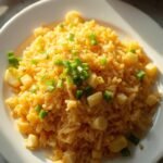 "Classic egg fried rice with fluffy scrambled eggs and green onion garnish on a clean white background"