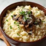 "Creamy mushroom risotto with Arborio rice, mixed mushrooms, and Parmesan in a rustic bowl on a clean marble background"