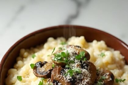 "Creamy mushroom risotto with Arborio rice, mixed mushrooms, and Parmesan in a rustic bowl on a clean marble background"